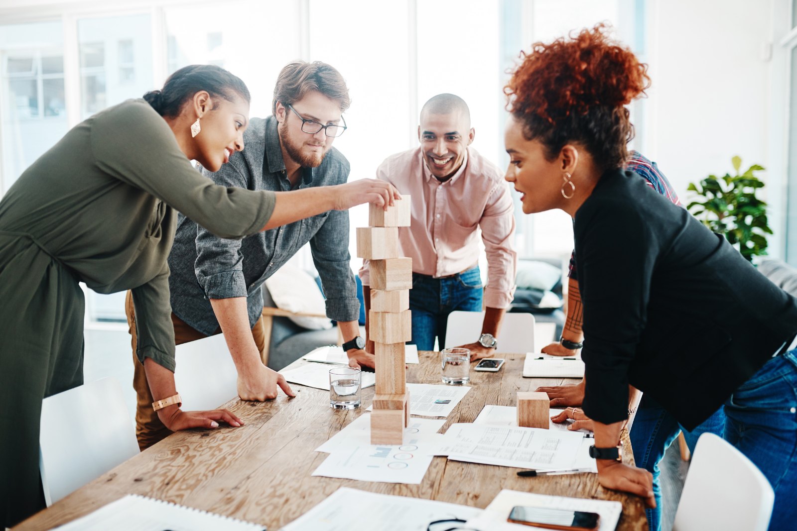 A team gathered around a table working through a problem together